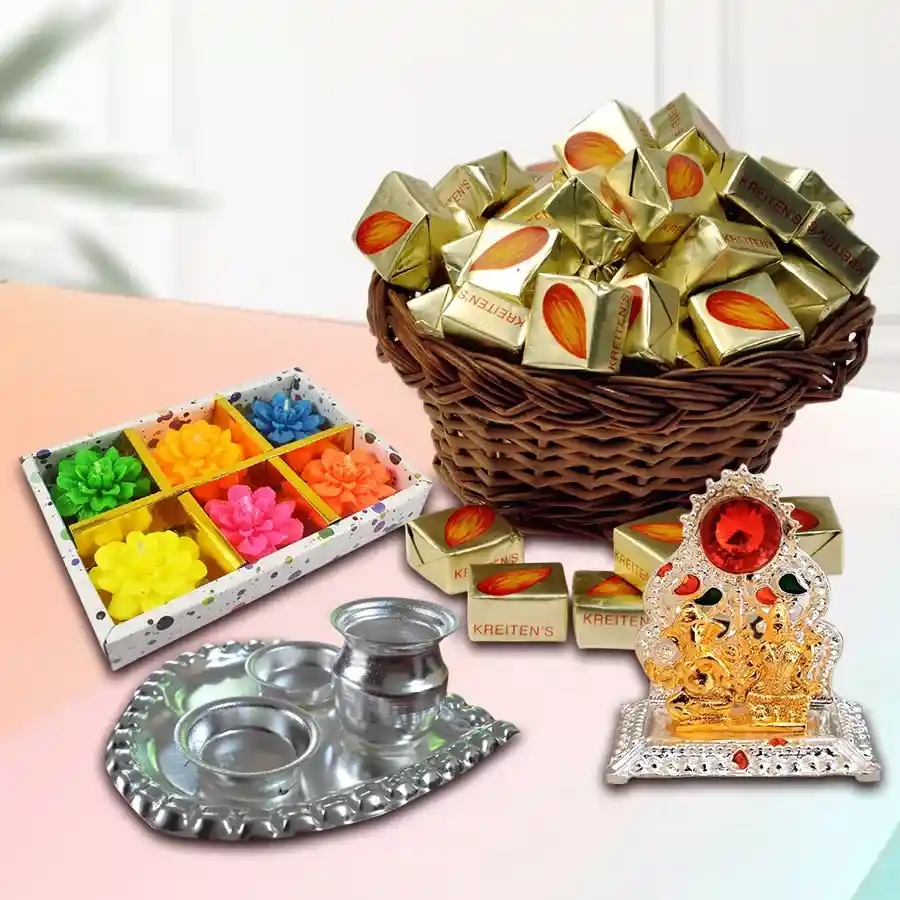 Exclusive Pooja Gift Hamper featuring Almond Toffees, antique Ganesh Laxmi Mandap, silver-plated paan-shaped puja thali, and flower-shaped wax candles