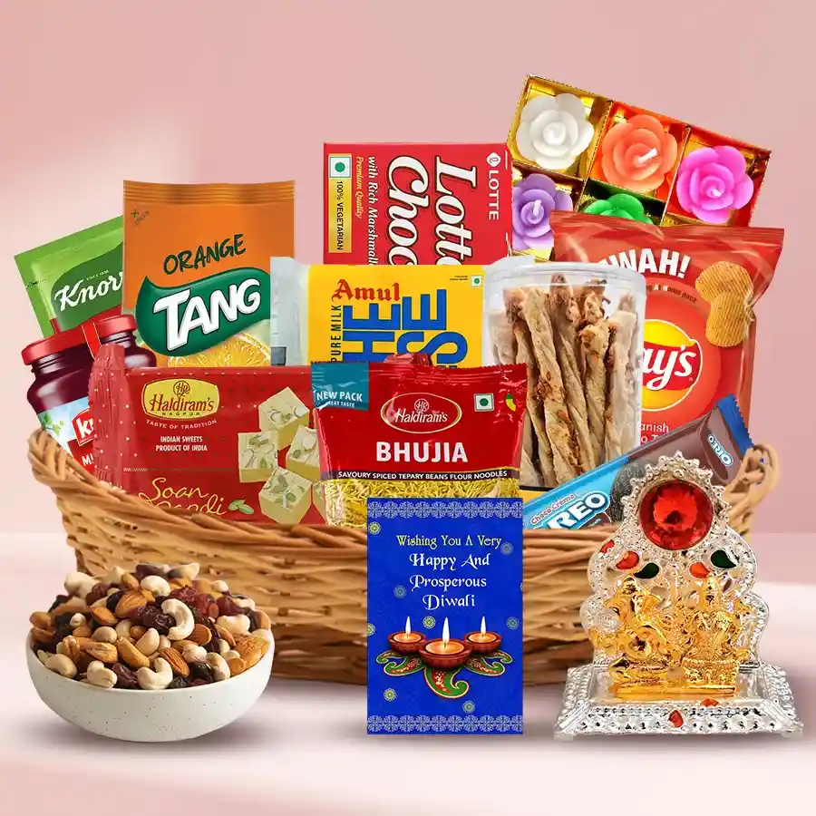 Delightful Sweets and Snacks Gift Hamper for Diwali featuring assorted treats, dry fruits, cheese, candles, and a Ganesh Mandap in a cane basket.