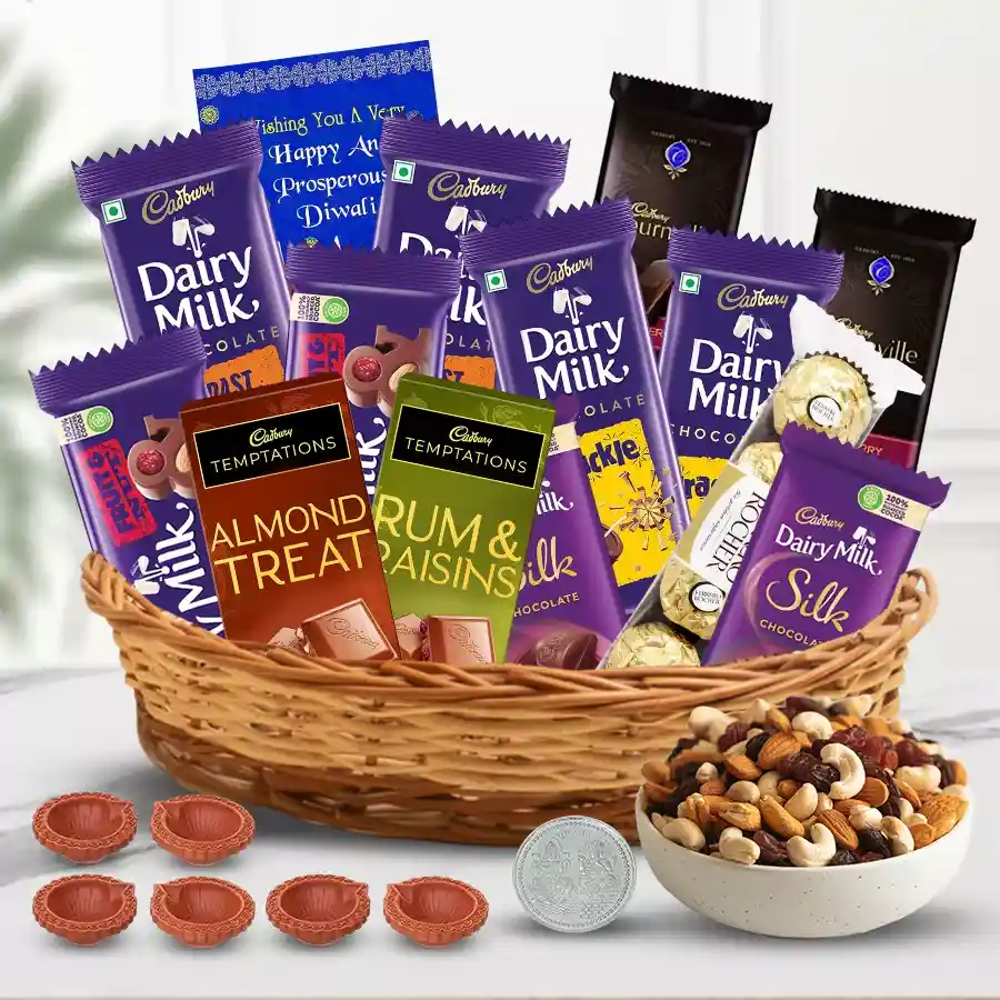 Exclusive Diwali gift hamper with chocolates, dry fruits, Mud Diyas, silver-plated Ganesh-Laxmi coin, and a greetings card.