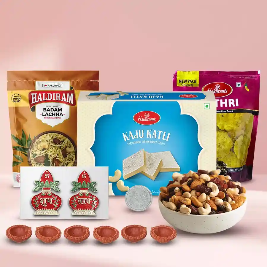Exclusive Sweets N Assortments Gift Hamper for Diwali featuring assorted dry fruits, Haldiram’s Kaju Katli, Badam Lachha, Methi Mathri, designer diyas, silver-plated Ganesh Lakshmi coin, and Subh Labh Wall Sicker.