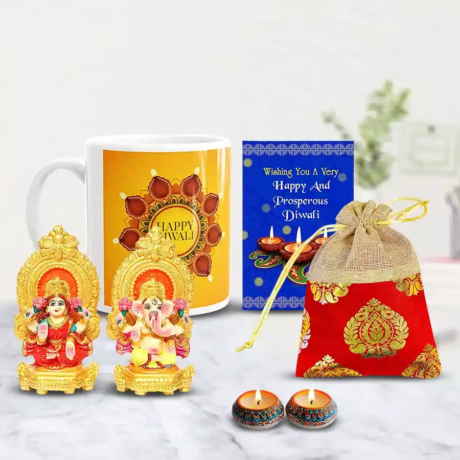 Propitious Ganesh Laxmi Idol with personalized coffee mug, assorted dry fruits in a designer potli, handmade wax candles, and Diwali greetings card arranged in a festive display.