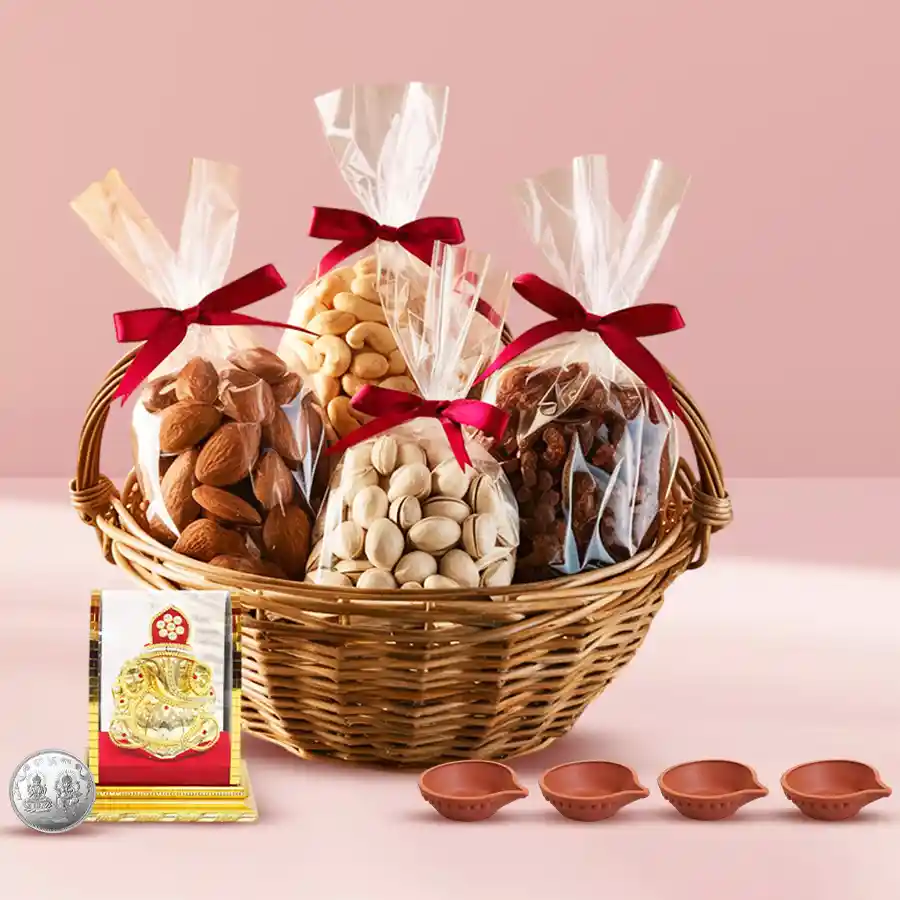 Exclusive basket of premium dry fruits with Ganesh idol, diya candles, and silver-plated coin for Diwali celebration.