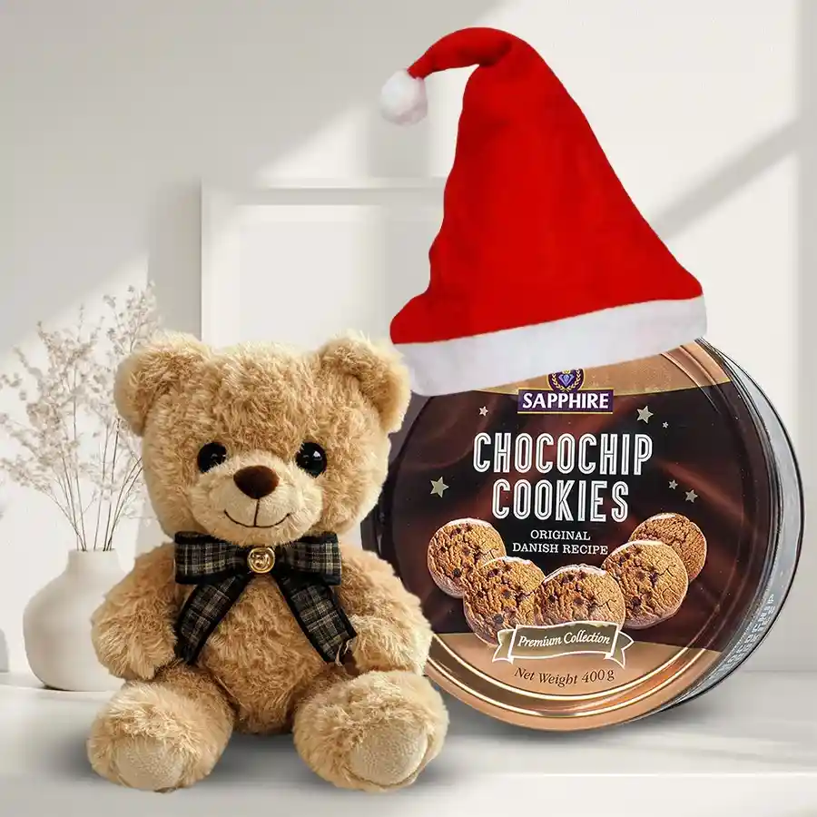 Exquisite Chocochip Cookies N Assortments Combo featuring a batch of chocochip cookies, a 9-inch teddy bear, and a festive Santa Claus cap