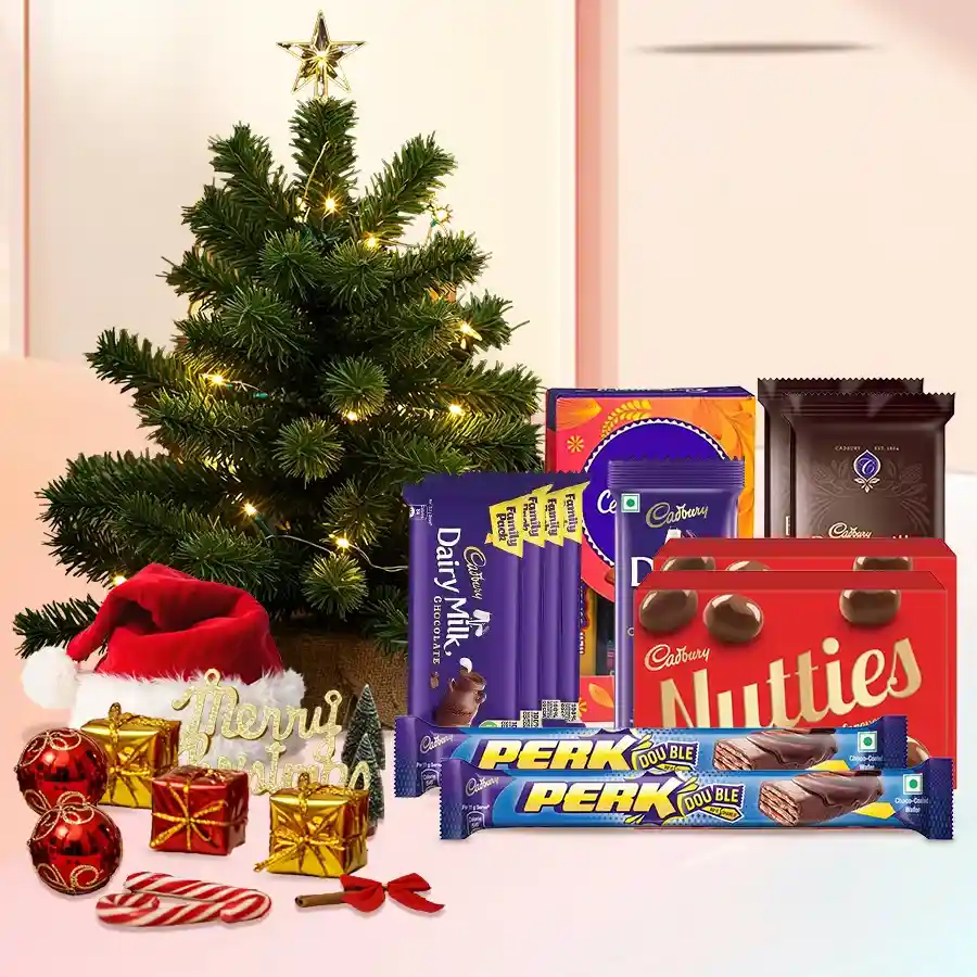 Exquisite Chocolates Gift Hamper featuring various Cadbury chocolates and a small decorated Christmas tree
