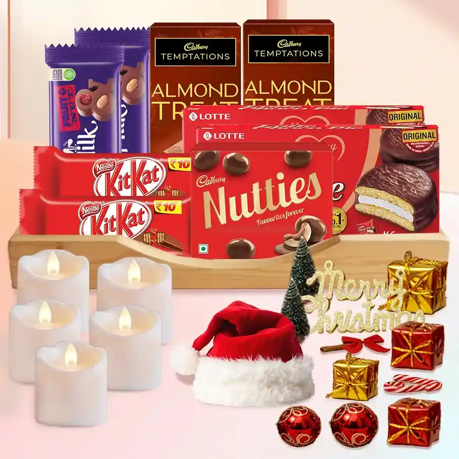Delightful Chocolates N Assortments Hamper featuring various chocolate bars, LED tea lights, a Santa Claus cap, Christmas decorations, and a stylish tray.