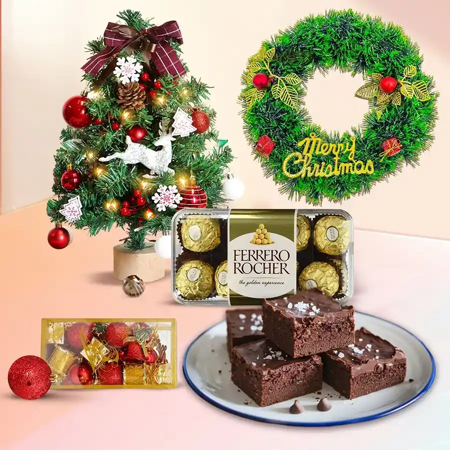 Delectable combo featuring rich brownies, luxurious Ferrero Rocher chocolates, a mini Christmas tree, a festive wreath, and sparkling decorations in a cheerful holiday setting