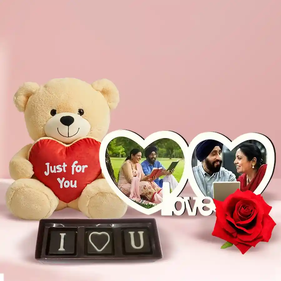 Personalized photo gift combo for Valentine's Day including a dual heart photo frame, handmade chocolates, a teddy bear, and a red velvet rose.