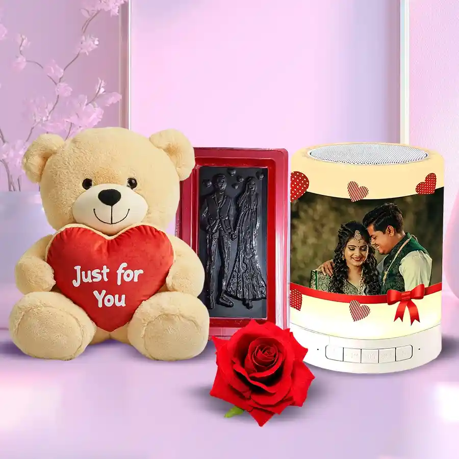 Valentine Special Gift Combo including a Personalized Photo Bluetooth Speaker, Valentine's chocolates, a Teddy bear, and a Red Velvet Rose.