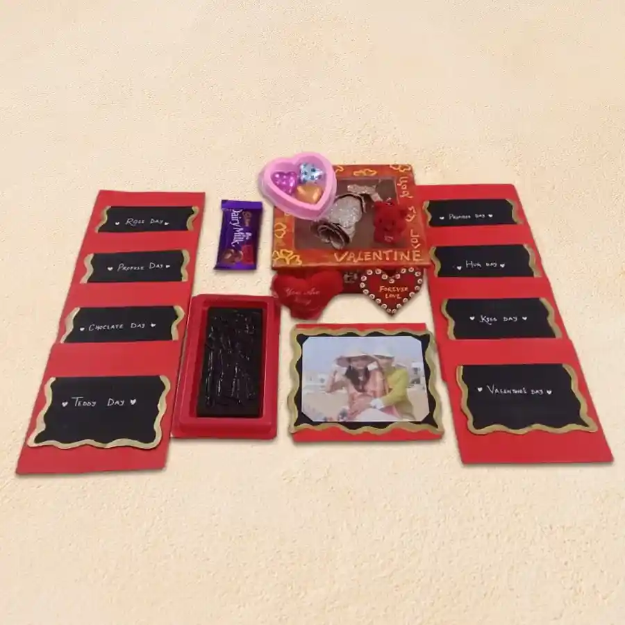 Attractive Valentine Week Gift Box featuring personalized photo and heartfelt messages with assorted treats including chocolates, teddy key ring, fridge magnet, gold rose, and heart-shaped cushion in a wooden box.