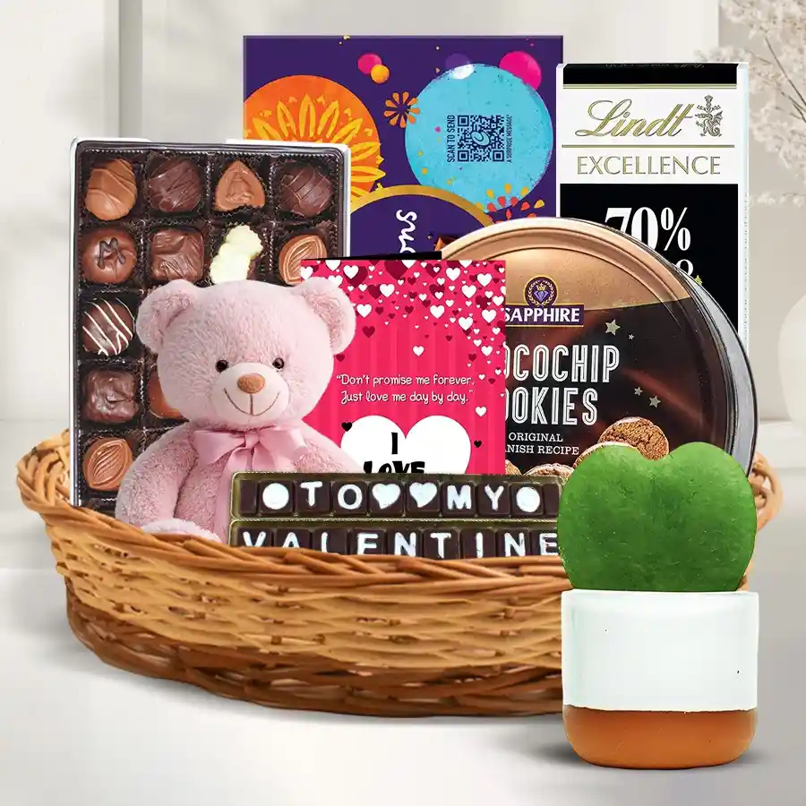 Fascinating Valentine Love Gift Hamper filled with chocolates, cookies, a teddy bear, a rose, a sweetheart plant, and a love card