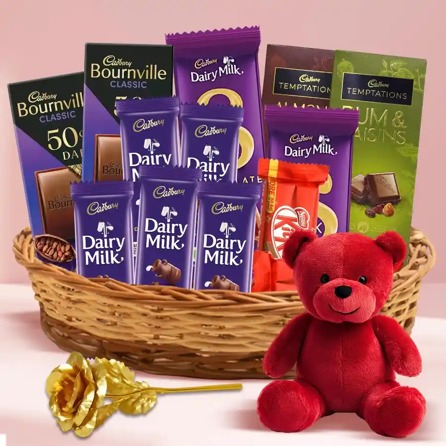 Impressive Chocolate Indulgence Gift Basket featuring Cadbury chocolates, Nestle KitKats, Bournville bars, a red teddy bear, and a golden rose