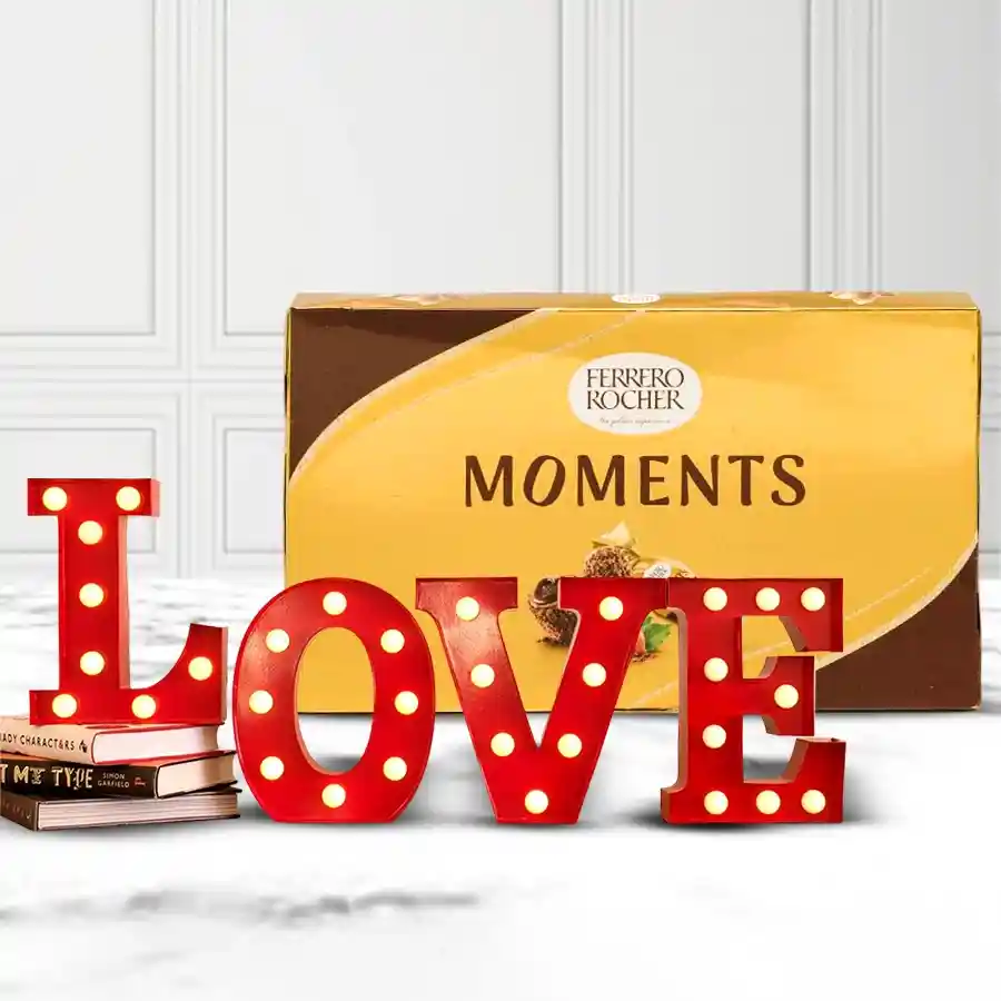 Lovely LOVE LED lamp next to a box of Ferrero Rocher chocolates, creating a romantic gift for Valentine's Day.