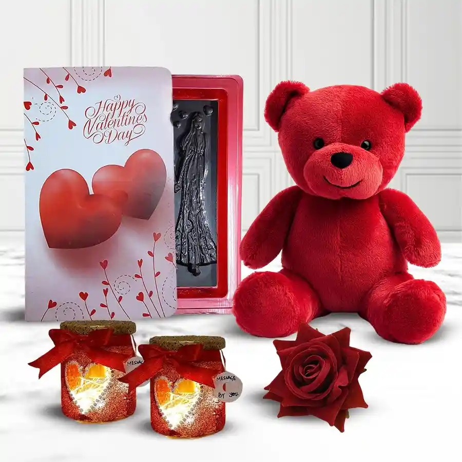 Gift set for fiancée featuring a plush red teddy, two heart-shaped LED lamps, Love Book chocolates, and a luxurious red velvet rose, all arranged for Valentine's Day.