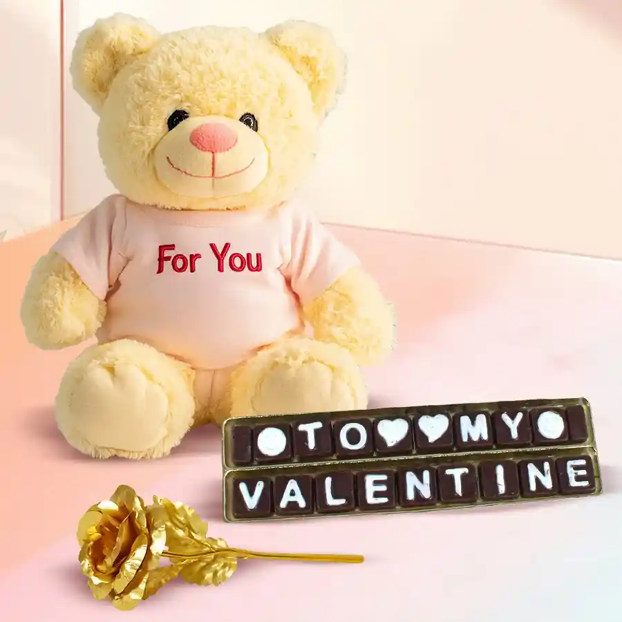 Cuddly teddy bear holding "Be My Valentine" chocolates and a shimmering golden rose