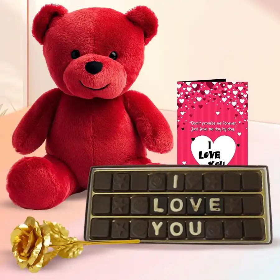 Charming Valentine gift set featuring a plush red teddy bear, handmade chocolates, a golden rose, and a heartfelt card