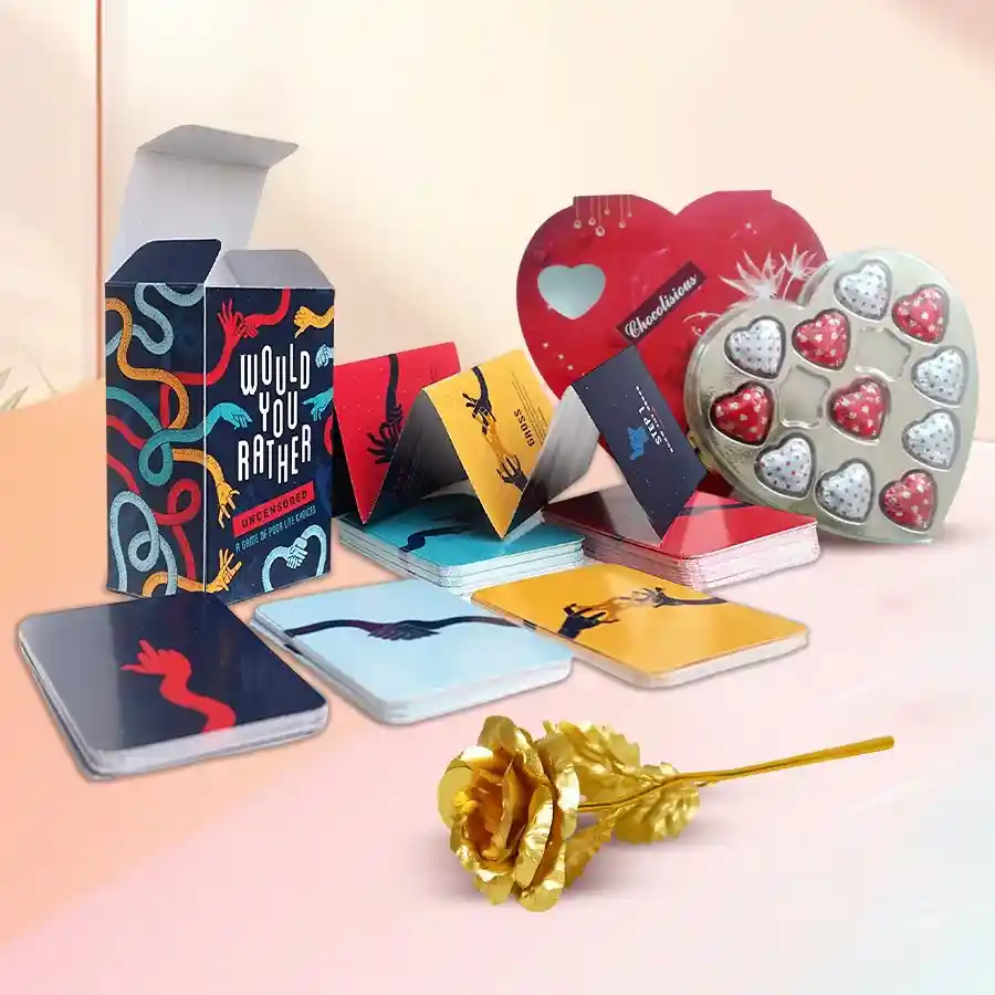 Seductive adult card game set with heart-shaped chocolates and a golden rose