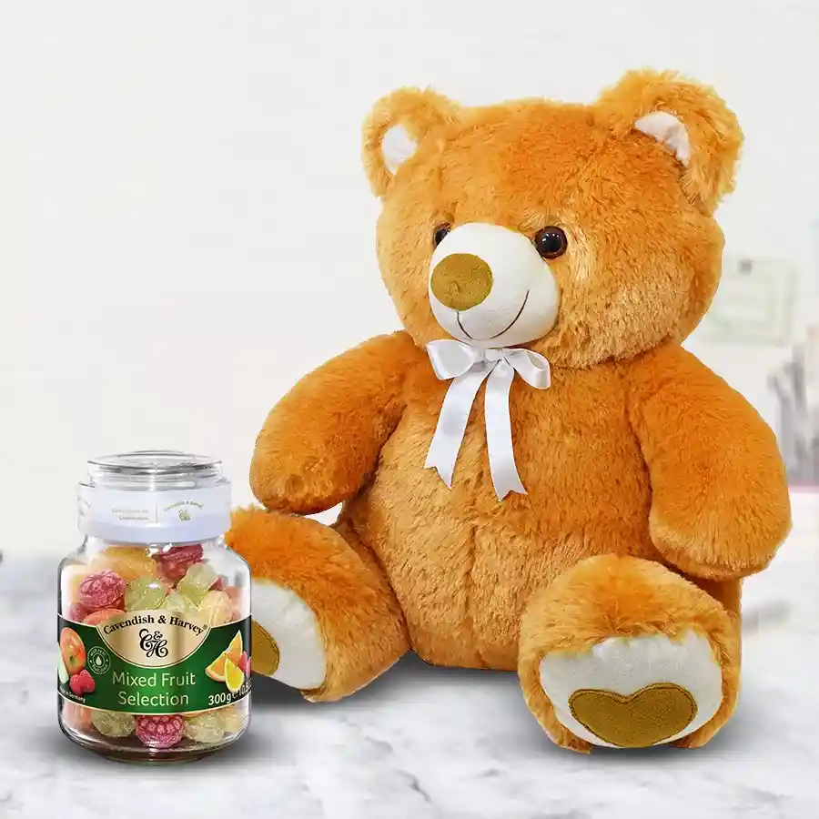 Cute 30 cm teddy bear next to a 300g box of Cavendish & Harvey Mixed Fruit Selection, ready to bring joy and sweetness.