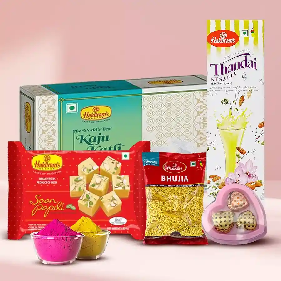 Enticing Haldirams Gift Hamper featuring Soan Papdi, Kaju Katli, Bhujia, Thandai, homemade chocolates, and herbal Holi colors.