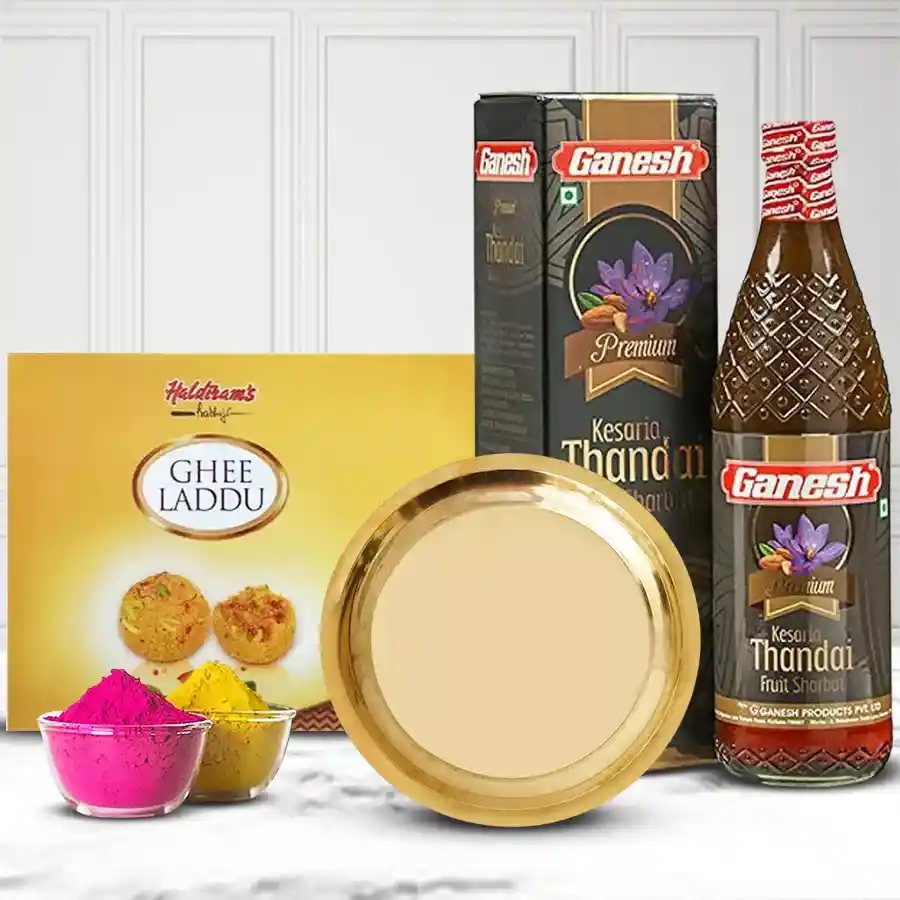 Traditional gold-plated thali set with Haldirams ghee laddu, Ganesh thandai bottle, and colorful Abir gulal for Holi celebrations