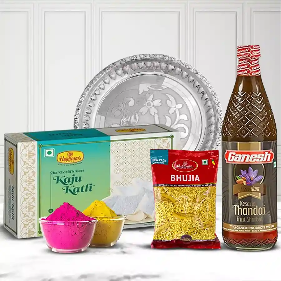 Traditional Silver Plated Thali with Holi gift assortments including Kaju Katli, Bhujia, Thandai, and herbal gulal