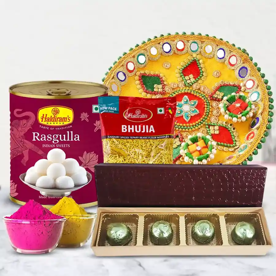 Exclusive Festival of Colors Gift Hamper featuring Haldirams Rasgulla, Bhujia, homemade chocolates, a designer Pooja thali, and herbal gulal.