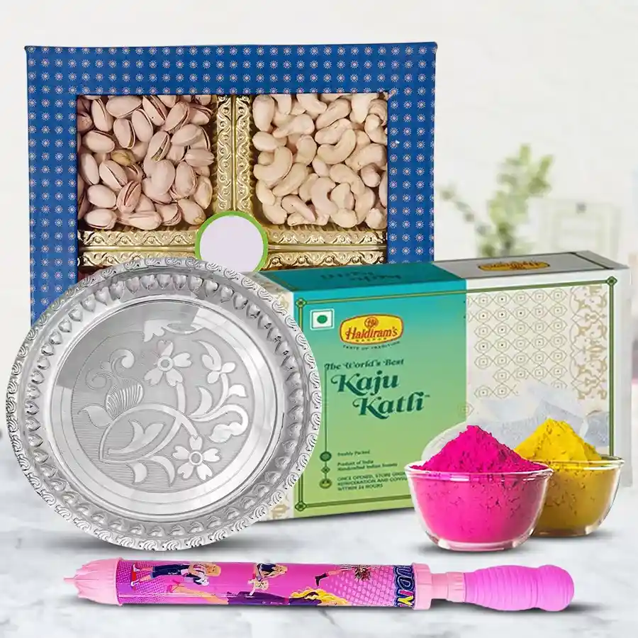 Wonderful Puja Thali set featuring a silver-plated thali, assorted dry fruits, Haldirams Kaju Katli, a colorful pichkari, and vibrant herbal gulal for Holi celebrations.