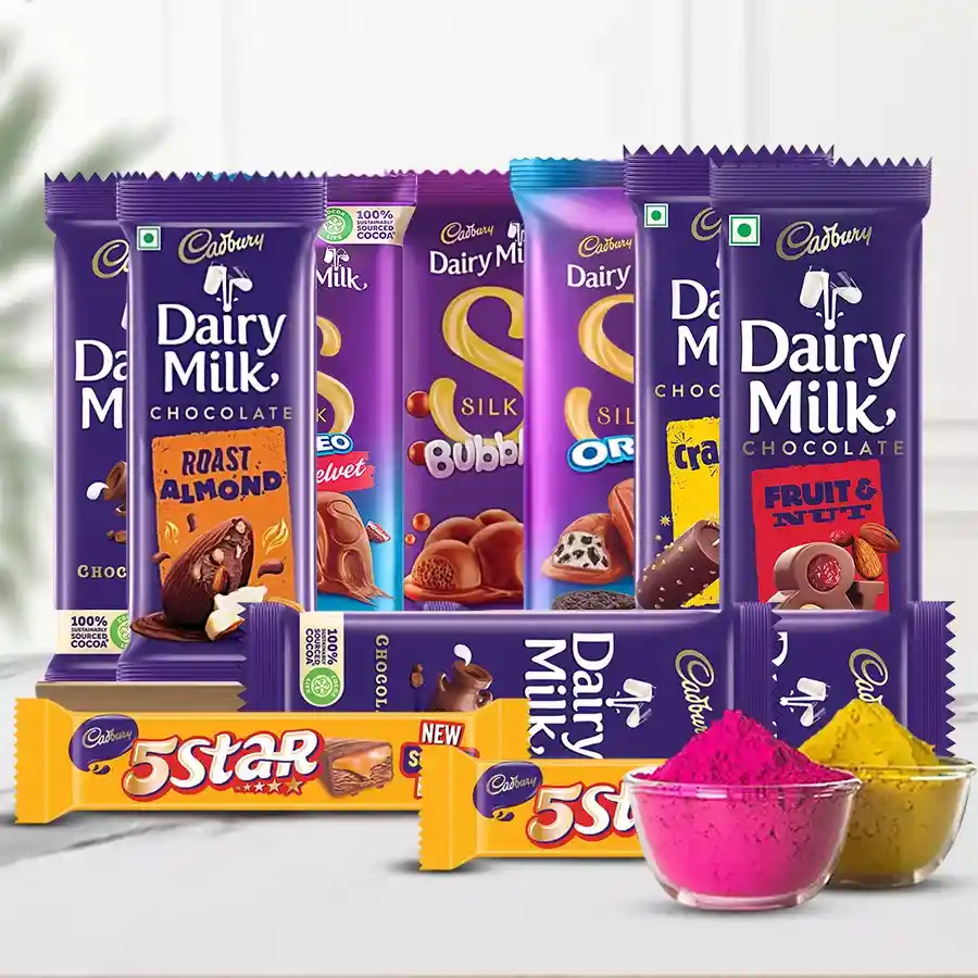 Scrumptious Chocos Gift Basket for Holi featuring assorted Cadbury chocolates, a black wooden tray, and colorful herbal gulal.