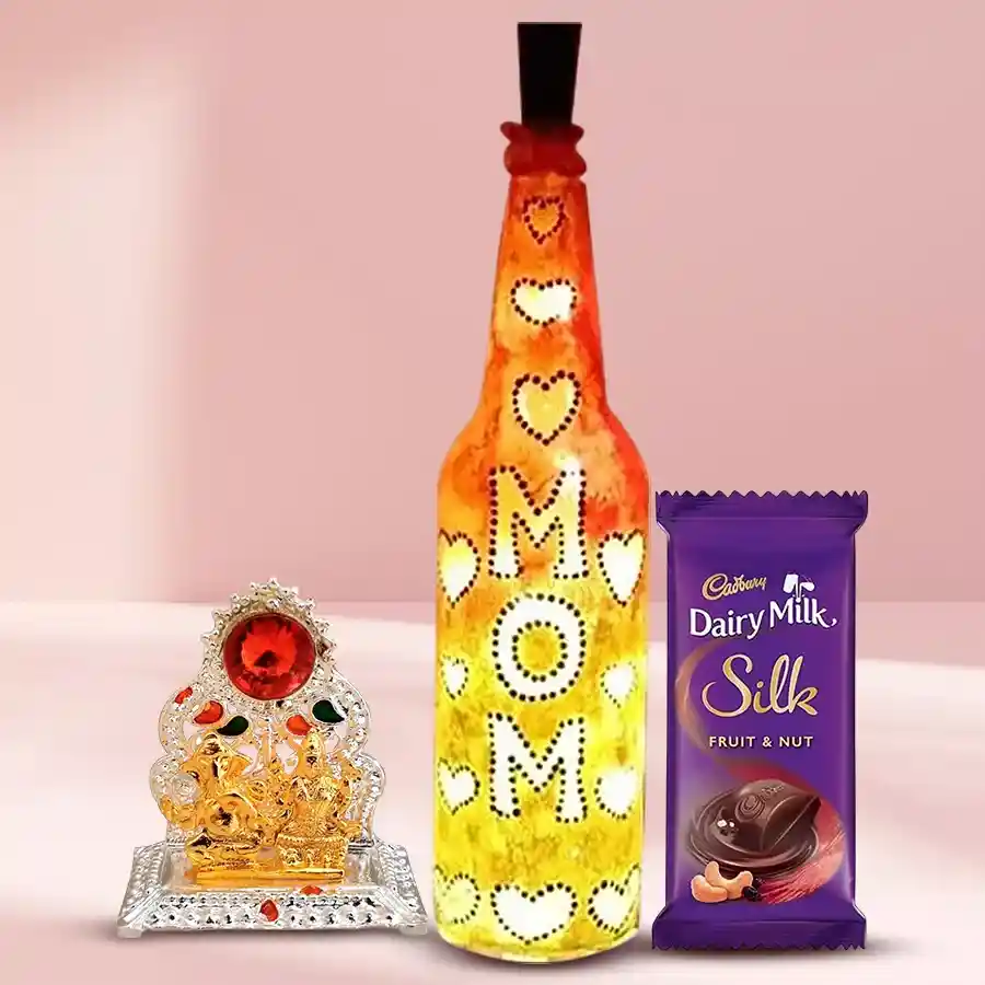 Handcrafted bottle lamp with Ganesh Laxmi Mandap beside Cadbury Dairy Milk Silk Fruit n Nut showcasing a heartfelt gift for Mom.