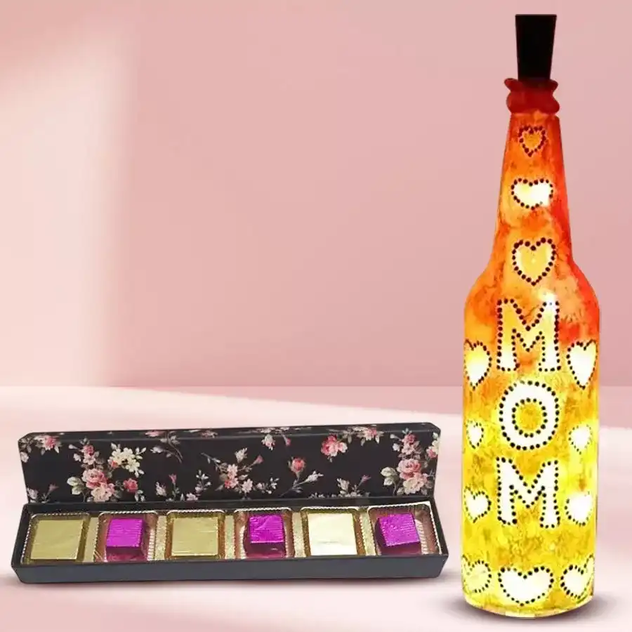 Handcrafted bottle lamp with warm LED glow alongside a box of handmade chocolates filled with dried mango and strawberry, perfect gift for Mom