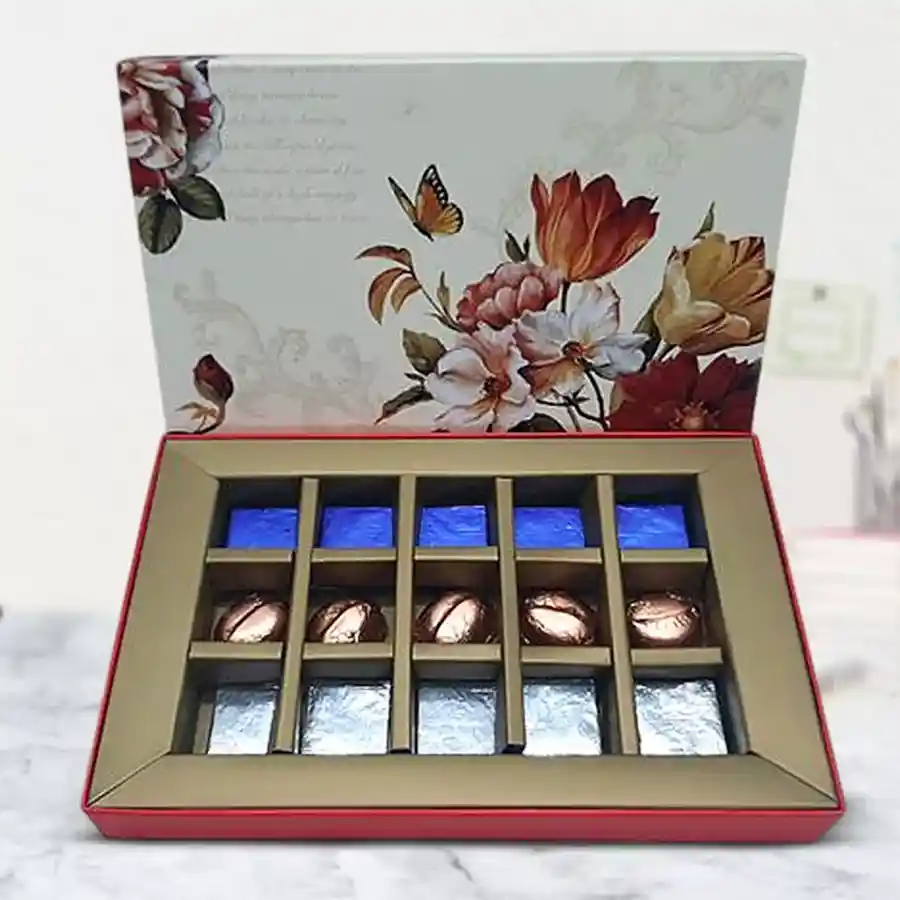 Handmade chocolates filled with dried kiwi, mango, and pineapple in a decorative box