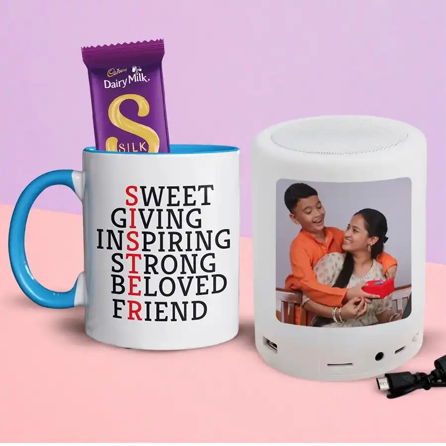Trendy Sister Coffee Mug with personalized design, Bluetooth speaker, and Cadbury Dairy Milk Silk chocolate bar arranged beautifully as a Raksha Bandhan gift set.