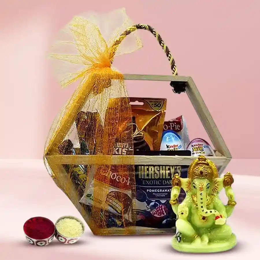 Bhai Dooj hamper featuring assorted chocolates, a glowing Ganesha idol, Roli Chawal, and a hexagonal wooden basket