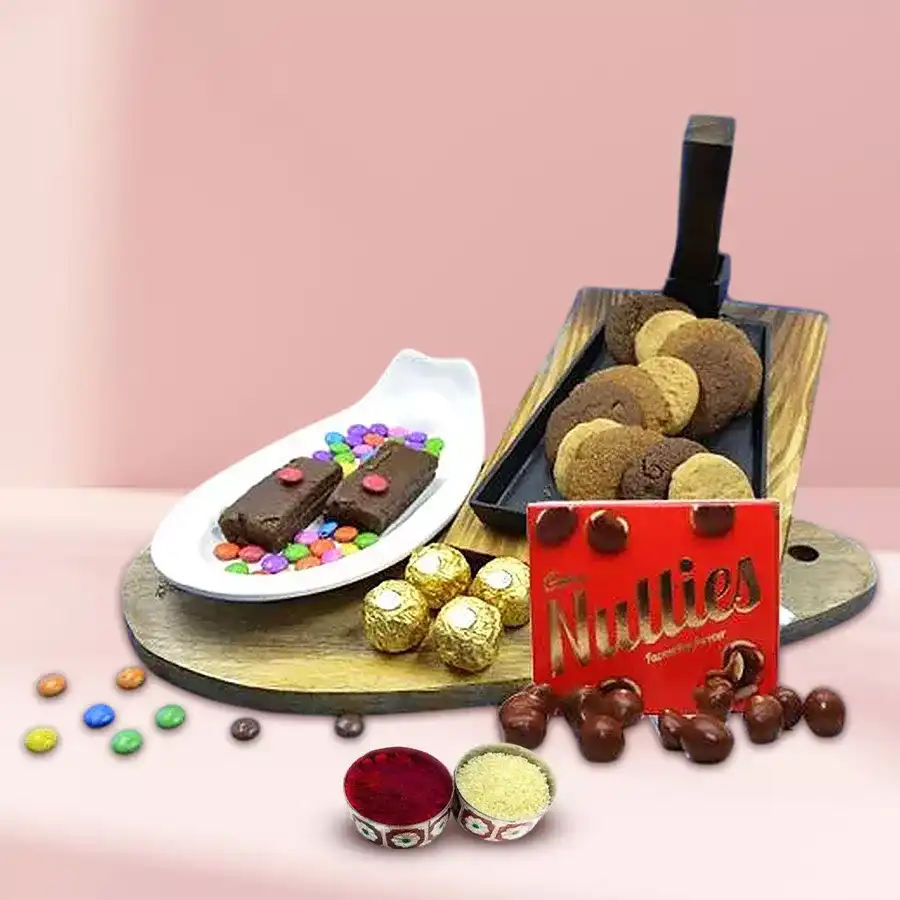 Oozing Class Chocolate and Cookie Hamper featuring assorted cookies, brownies, Ferrero Rocher, Cadbury Nutties, LED Tower Lamp, and Roli Tika set