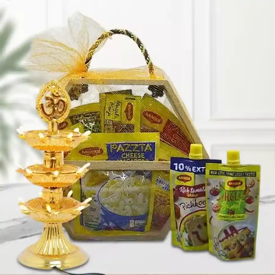 Trendy Maggie Magic Delight gift hamper with masala noodles, pasta, sauces, LED Tower Lamp, Roli, Teeka, Chawal arranged in a hexagonal wooden basket.