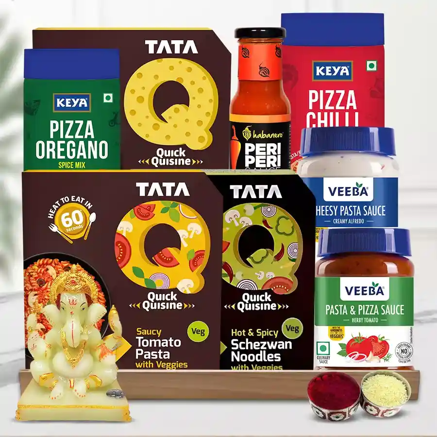 Special Pasta and Noodles Gift Hamper featuring TataQ products, Veeba sauces, Keya seasonings, a glowing Ganesha idol, Roli Teeka, and a wooden tray, designed for Bhai Dooj celebrations.
