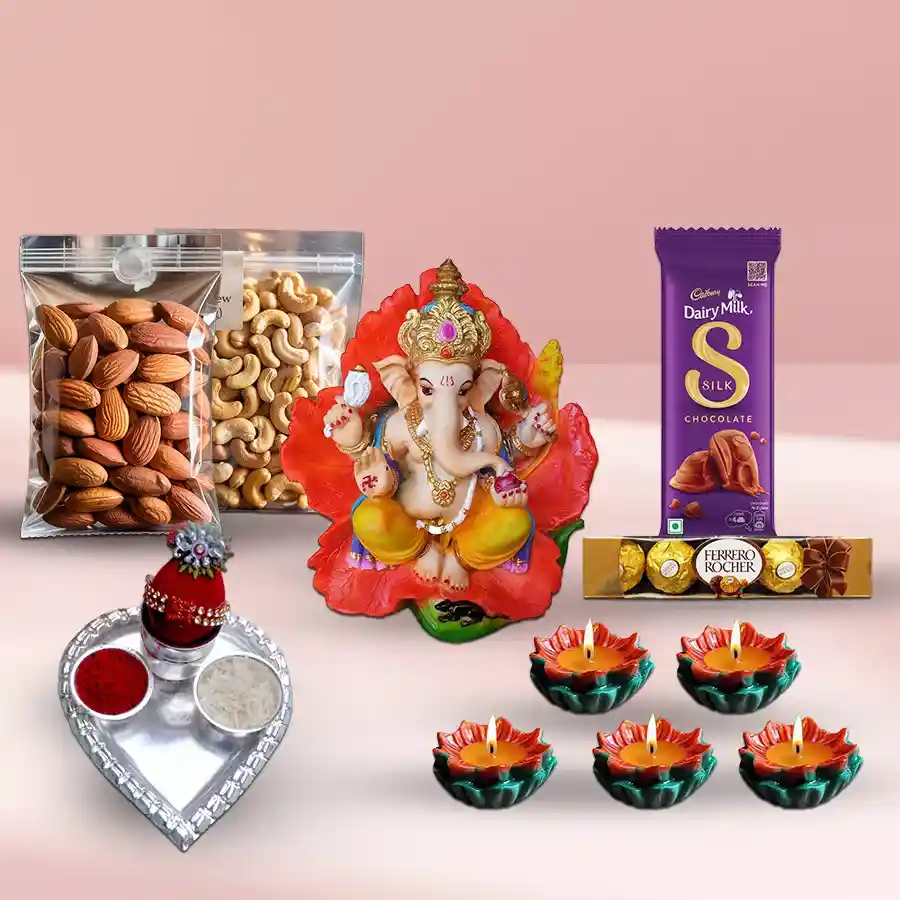 Puja thali gift hamper with dry fruits, chocolates, Ganesh idol, diyas, and decorative box for Diwali celebration