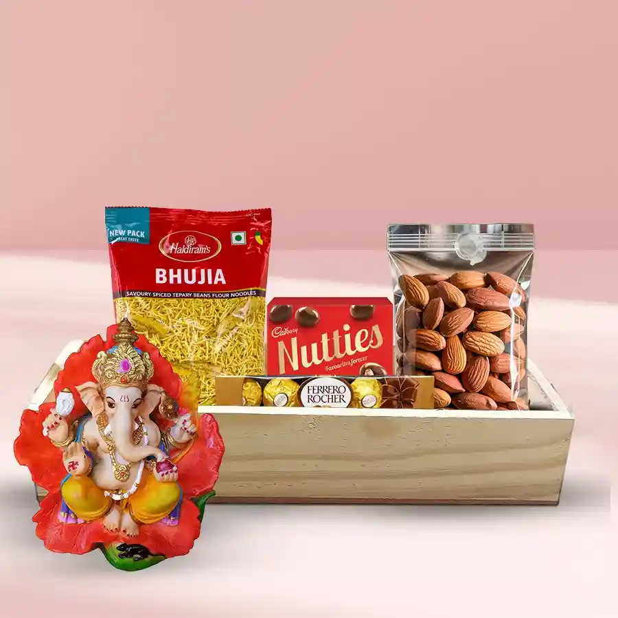 A beautifully arranged gift hamper featuring premium almonds, Ferrero Rocher chocolates, Cadbury Nutties, Haldiram Bhujia, a Vighnesh Ganesh Idol, and a wooden tray, perfect for Diwali celebrations.