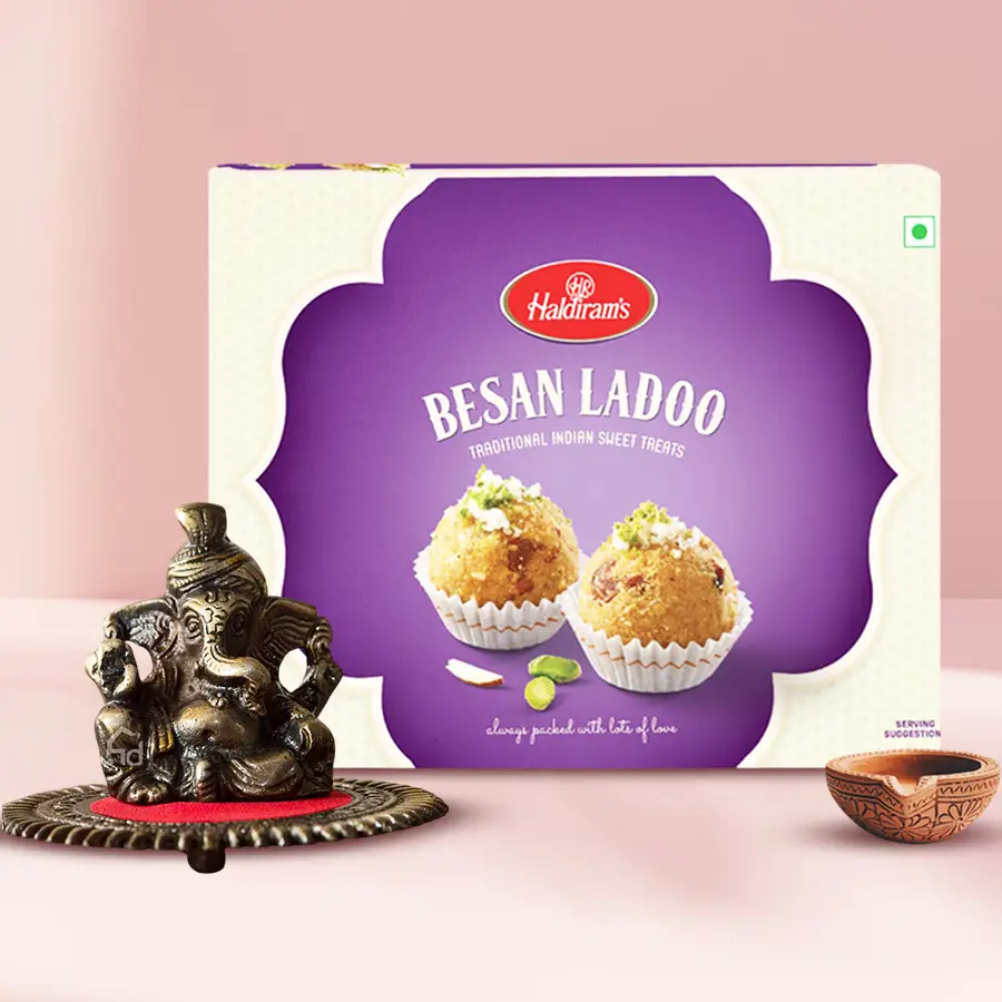 Crafty Metallic Pagdi Lord Ganesha on round base with sweets and a terracotta diya