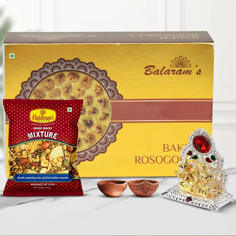 Yummy Balaram Mullick's Baked Rasogulla with Haldiram Mixture presented in a Religious Ganesh Laxmi Mandap alongside traditional Diyas for Diwali celebrations.