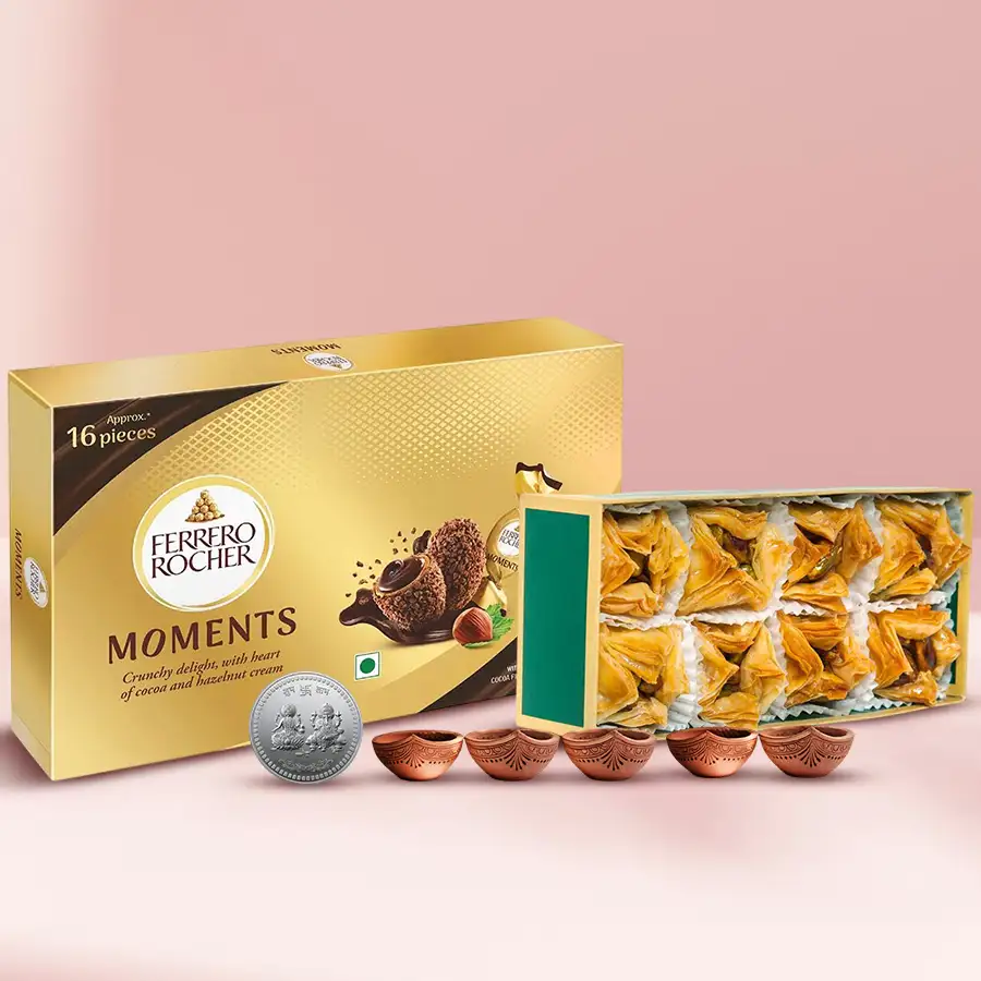 Finest Pyramid Baklawa with Ferrero Rocher Moments, silver-plated Ganesh Laxmi coin, and decorative diyas for Diwali celebration.