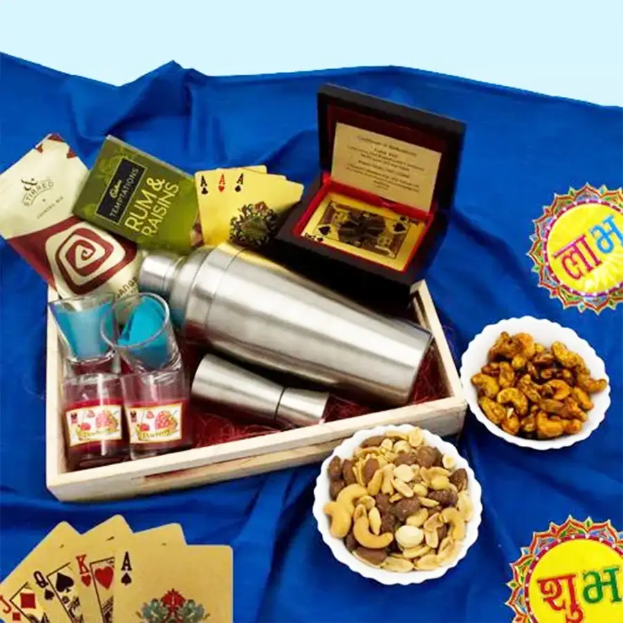Ideal Diwali Night Combo featuring cocktail mix, poker cards, shot glasses, cocktail shaker, sangria mix, salted nuts, cashews, Cadbury chocolates, 24K gold-plated playing cards, and aromatic candles