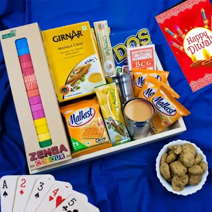 Refreshing Cutting Masala Chai Hamper for Diwali featuring Girnar Instant Chai Masala, Haldiram Methi Mathri, Malkist Cheese Crackers, steel cutting chai glasses, Mattel Uno cards, wooden Zenga blocks, and a stylish wooden tray.