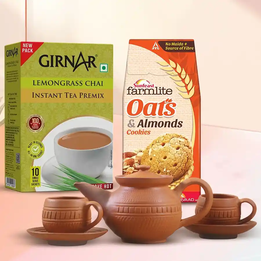Showy Girnar Lemongrass Tea Hamper featuring a terracotta tea set, 10 sachets of lemongrass chai, and a pack of Sunfeast Farmlite Active Oats biscuits.