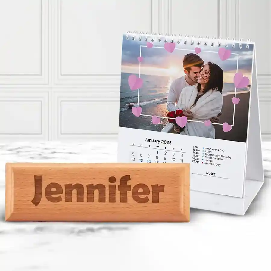 Personalized engraved wooden name plate with custom photo and sleek desk calendar displayed together on a desk.