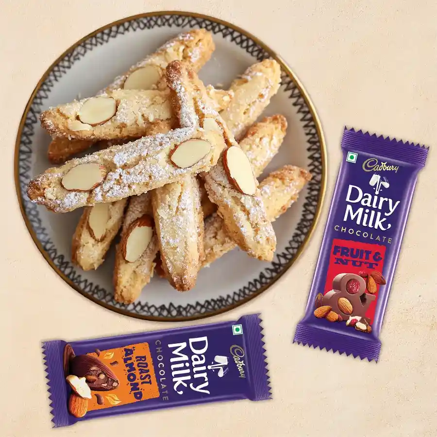 Santa's Cadbury Silky Gift box featuring Dairy Milk Silk Fruit and Nut, Silk Roast Almond bars, and Almond Fingers cookies for Christmas.