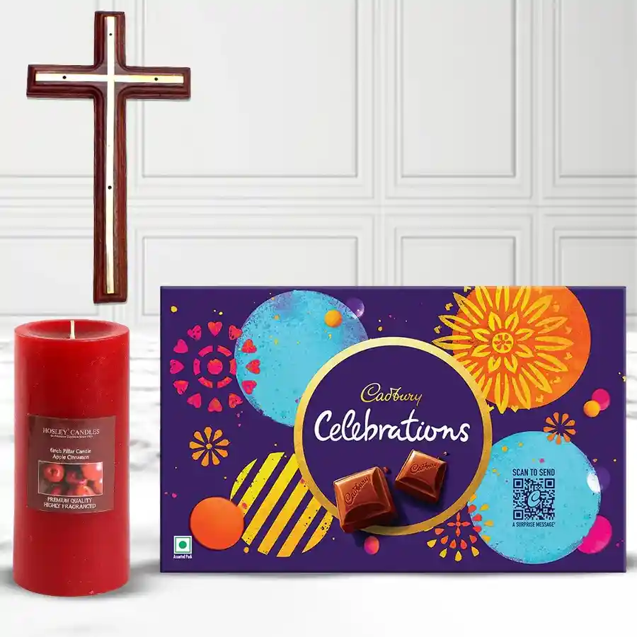 Christ Cross wall hanging, apple cinnamon-scented pillar candle, and Cadbury assorted chocolates in a gift combo arrangement.