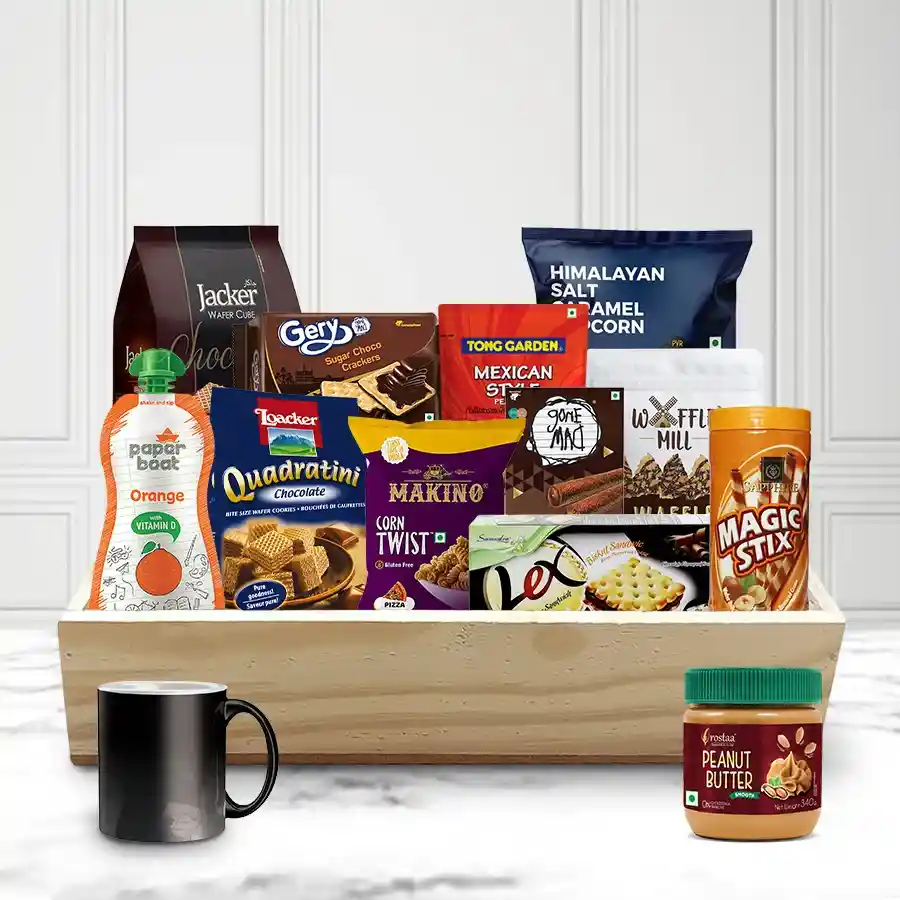 Joyous Christmas Gift Basket filled with gourmet snacks and treats, including popcorn, biscuits, and a reusable tumbler, presented in a stylish wooden tray.