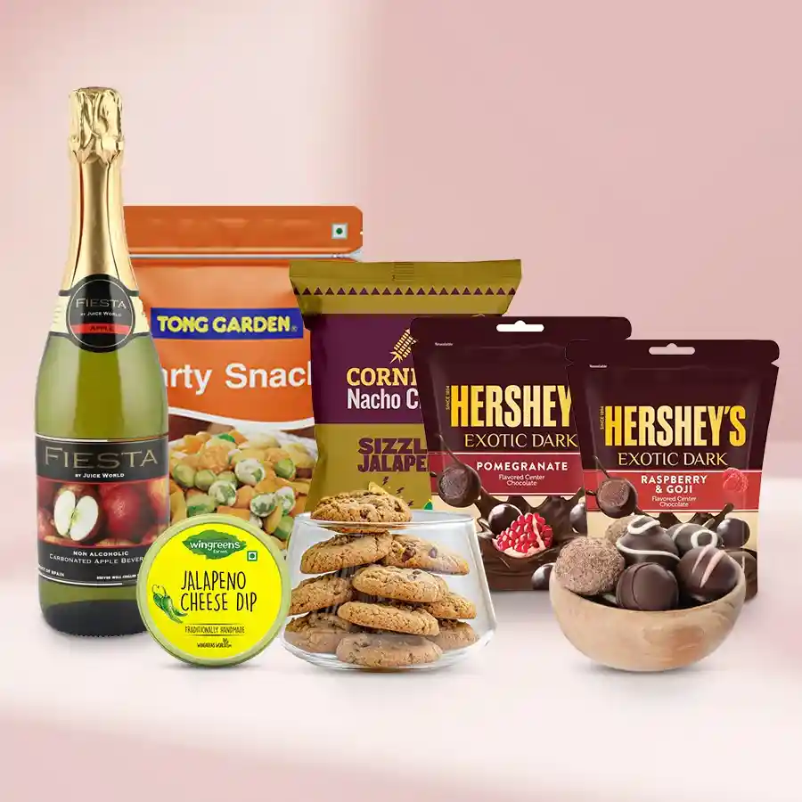 Truly Exotic Gourmet Gift hamper featuring nuts, cookies, chocolate balls, dark chocolates, nachos, cheese dip, and sparkling fruit juice for Christmas.