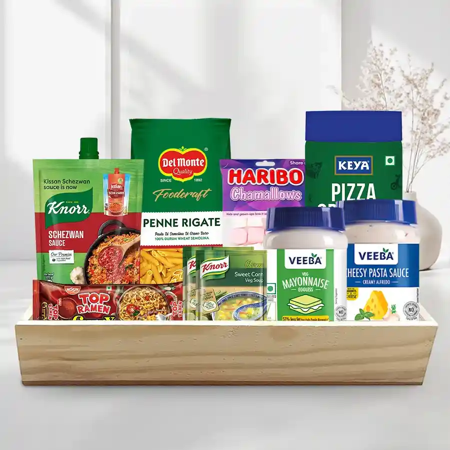Sensational Selection Breakfast Basket featuring noodles, sauce, pasta, oregano, dressings, soup, marshmallows, and a wooden tray.