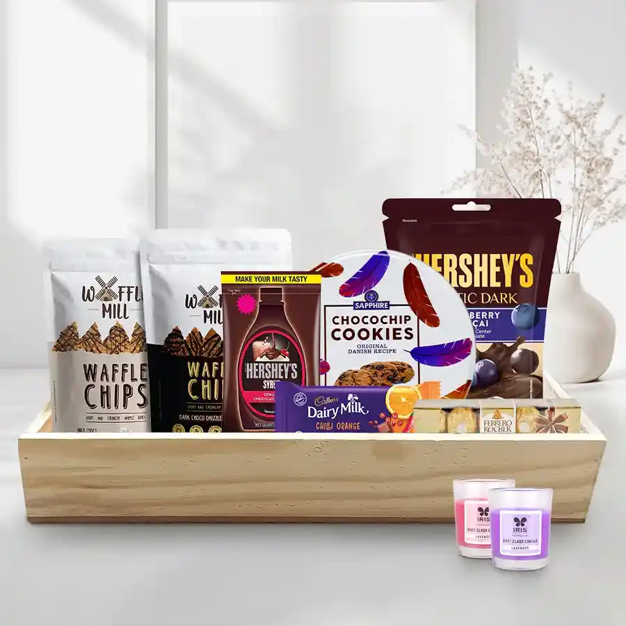 Special Evening Pleasure Christmas Basket featuring sweets, cookies, chocolate syrup, candles, and a wooden tray